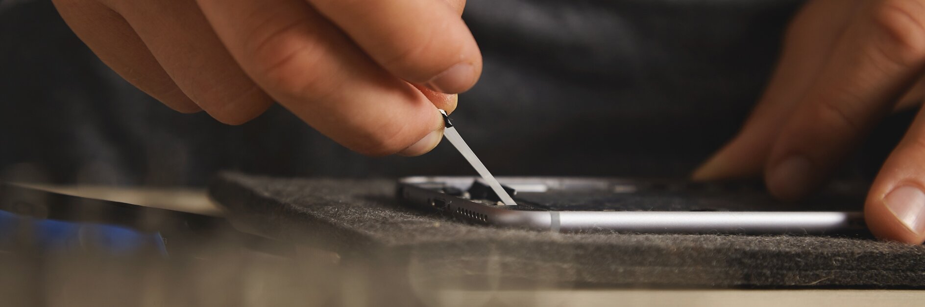 Using hands to remove battery glue from opened smartphone to replace and fix it with new one