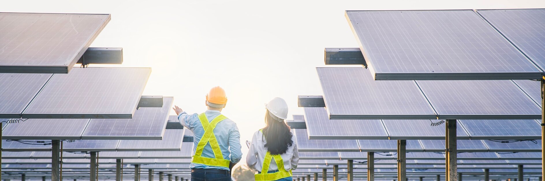 Male and female employee maintenance panels collect solar energy. Engineer working on checking and maintenance equipment at industry solar power.