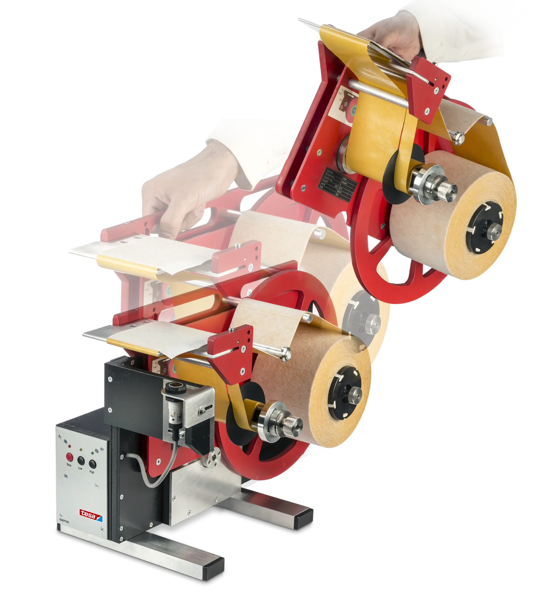 A person operates a red and yellow industrial labeling machine. The machine holds multiple rolls of label tesa tape and cardboard spacers. A control box is attached, featuring switches and a red and silver logo.