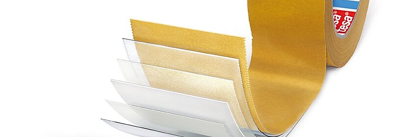 A roll of brown adhesive tesa tape is shown with several overlapping peeled layers, revealing different transparent sections. The tesa tape roll has a red and white branded core.