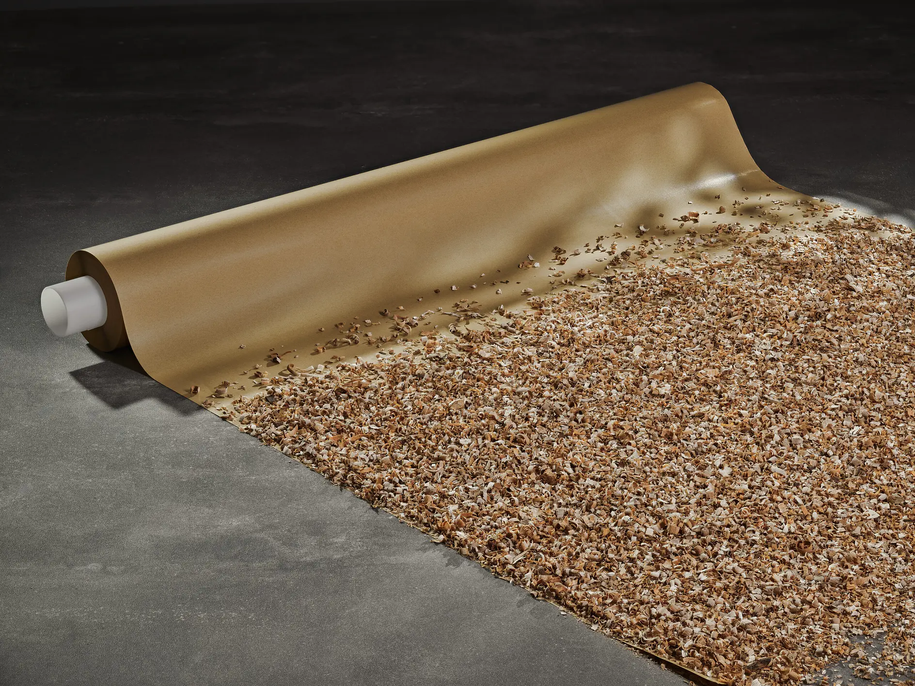 roll of tesa adhesive carpet protector partially unrolled on concrete floor, showing textured surface and backing layer