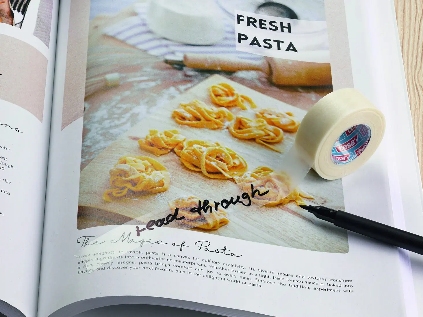 An open cookbook on wood displays a pizza recipe and fresh pasta photo, with a pen and a roll of tesa tape sitting on the pages. (This text has been generated by AI)