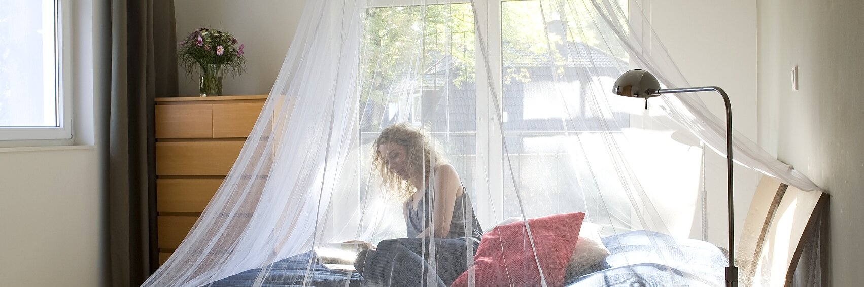A mosquito net provides insect protection and is attached to the ceiling in the bedroom of your home or while traveling.