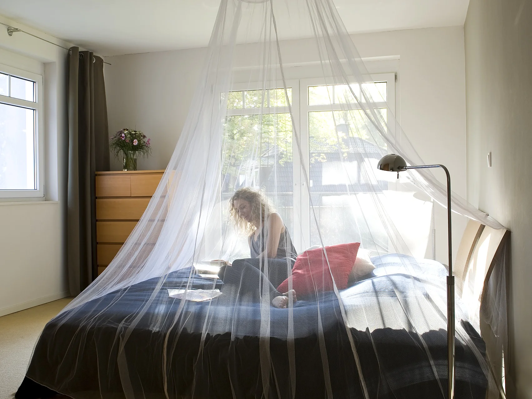 A mosquito net provides insect protection and is attached to the ceiling in the bedroom of your home or while traveling.