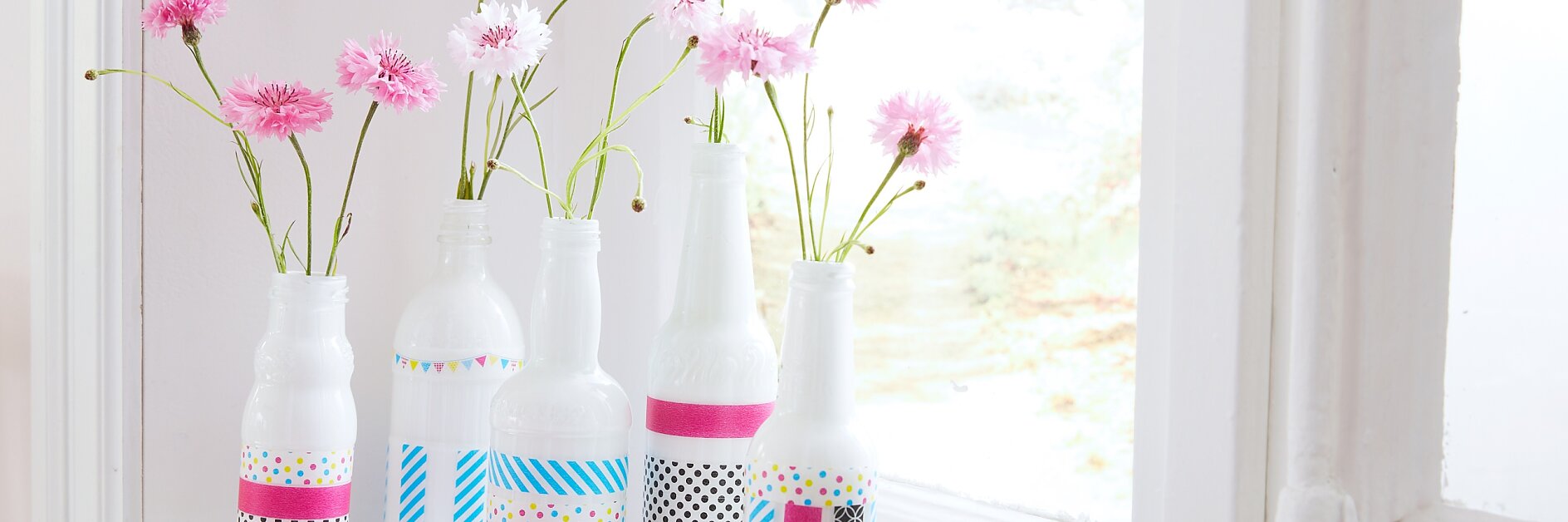 Final result of our DIY vase idea with flowers. This vase is made out of bottles and deco tape.