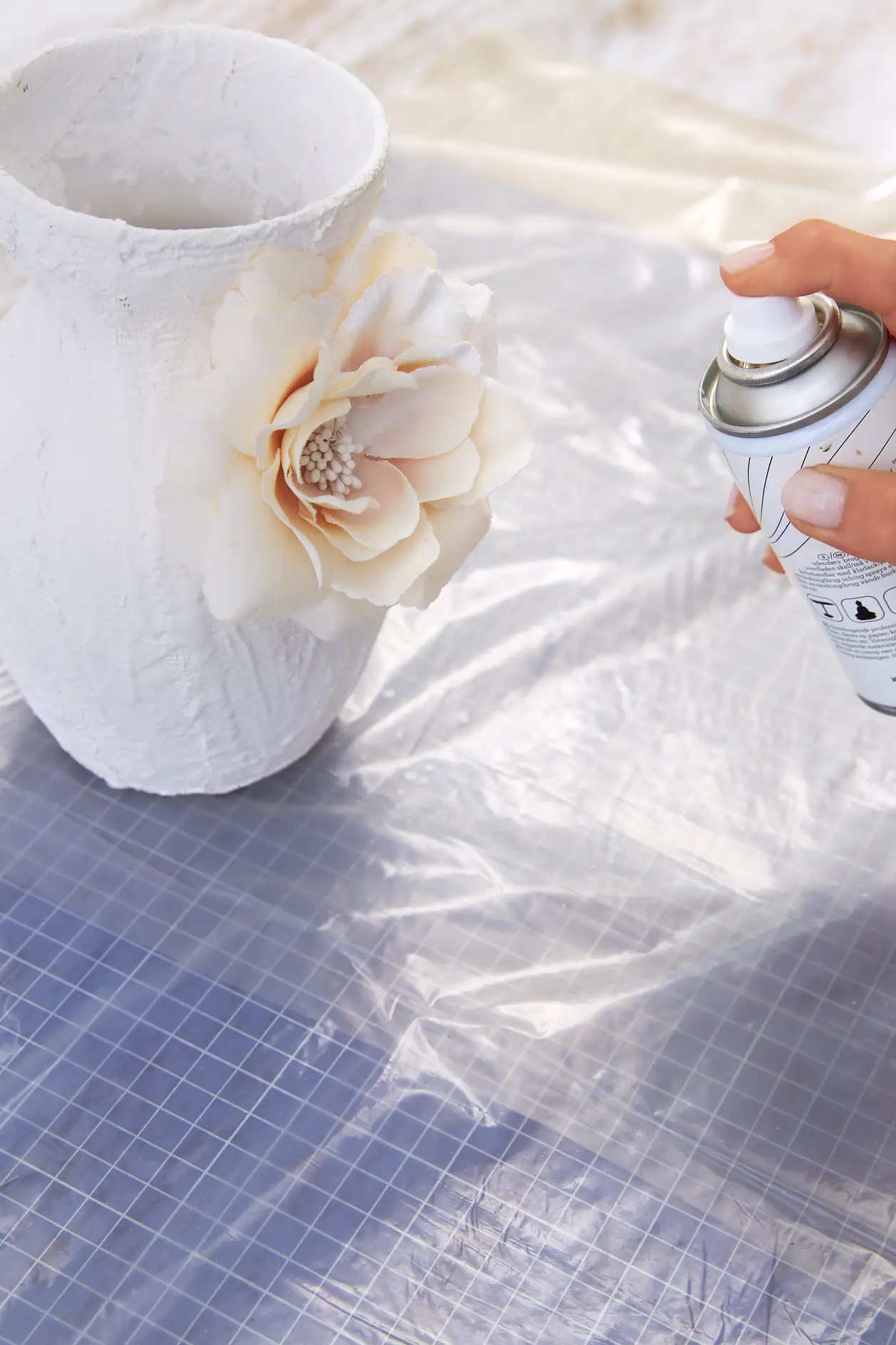 Once all is well dried up, finish the vase with white spray paint.