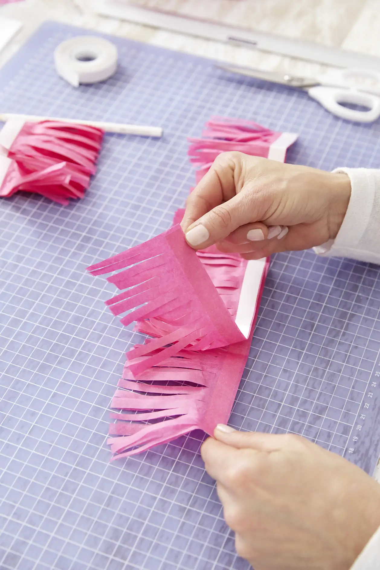 Unfold the strips to create a pompom
