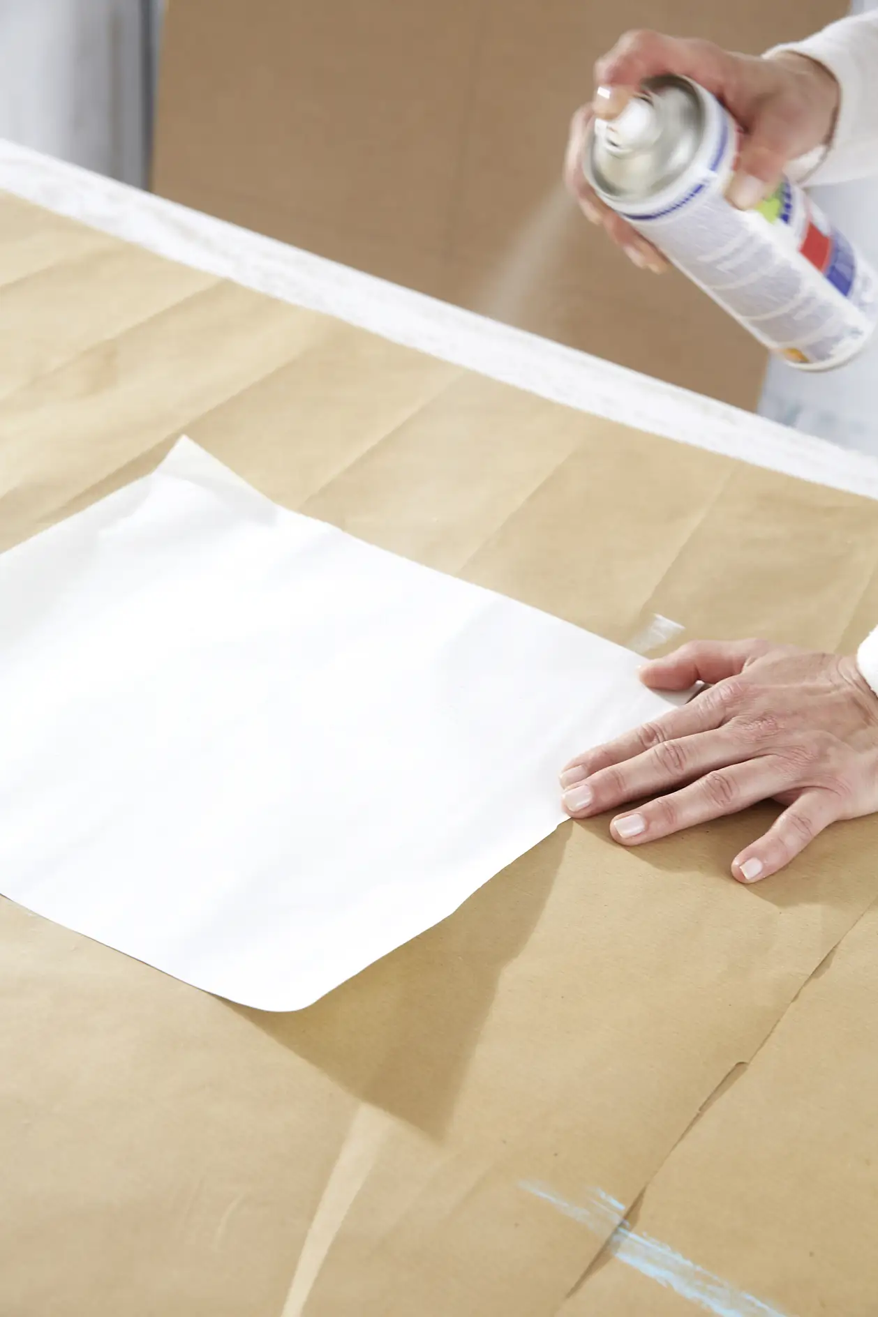 Cut your paper to match the pencilled areas and spray the back sides with tesa® Spray Glue PERMANENT