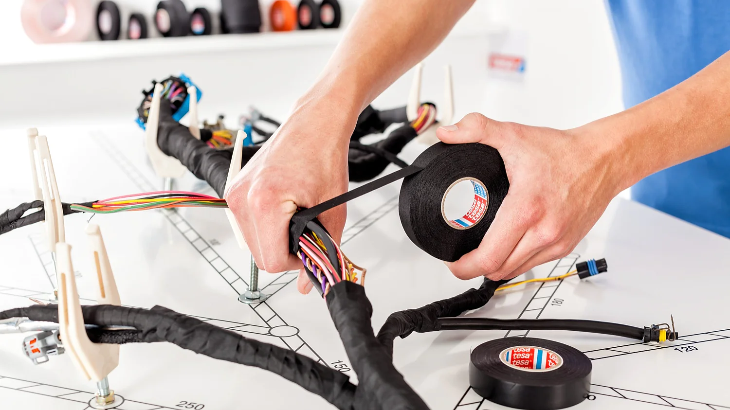 The increasingly complex structure of wire harnesses and cramped quarters in the engine compartment and vehicle interior are a major challenge for manufacturers of wire harnesses. tesa Automotive offers an extensive range of products for wire harnessing, consisting of fabric, nonwoven fabric, and fi lm backings with high-quality adhesives.