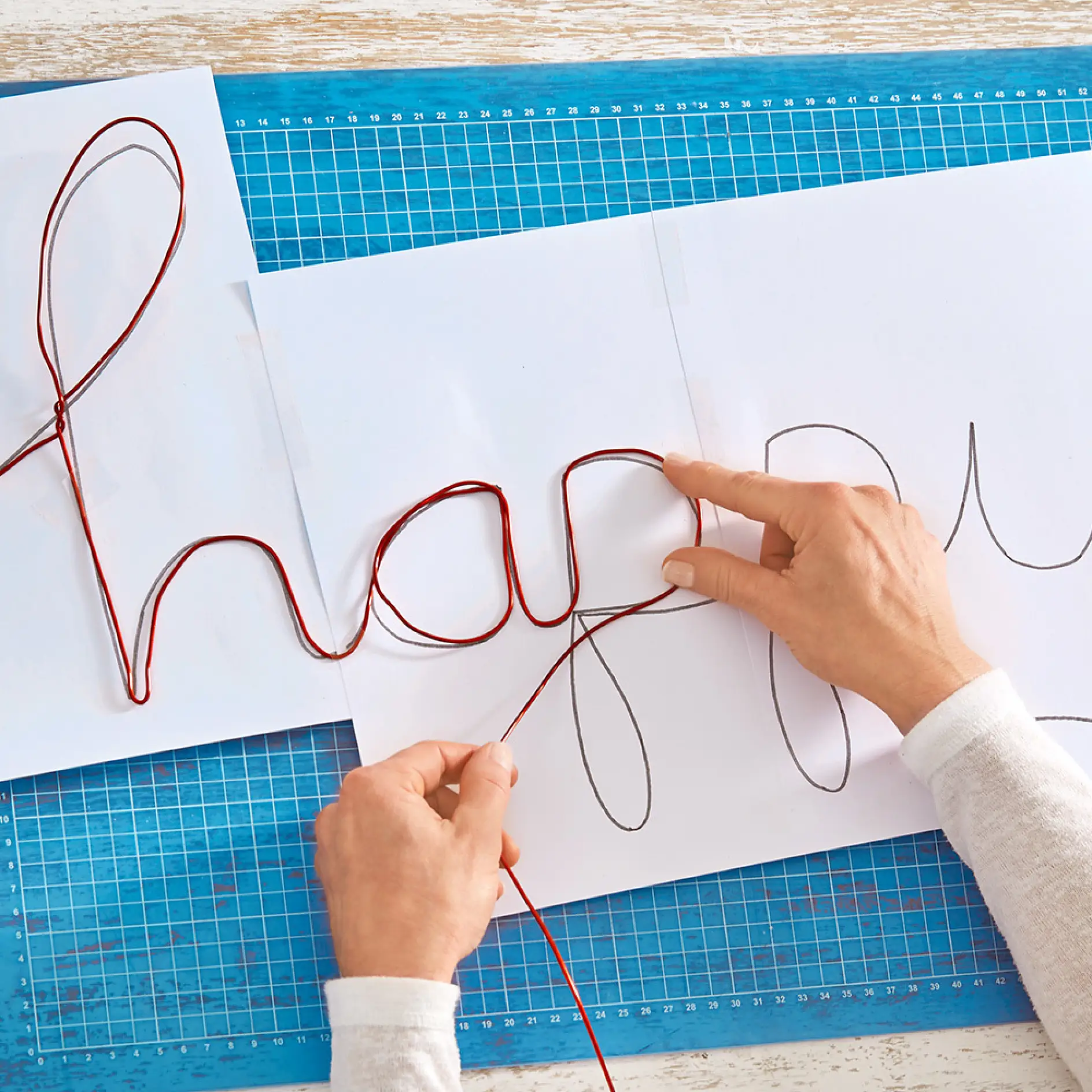 Using the template and wire to create a wire writing sign.