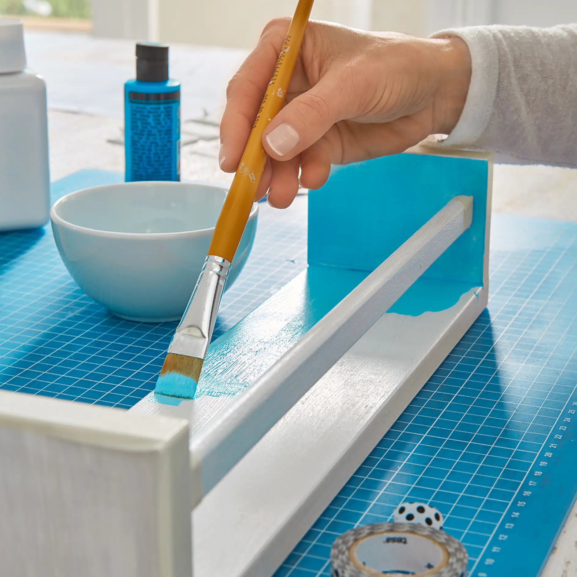 Painting the inside of the spice racks when making shelves – a great bathroom storage idea.