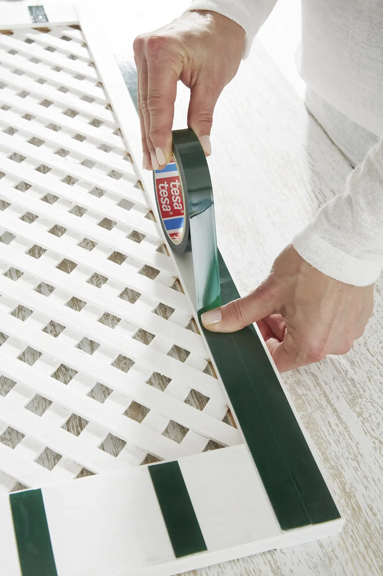 Remove any dust and apply two strips of tesa Powerbond® OUTDOOR on the reverse. Press for five seconds.