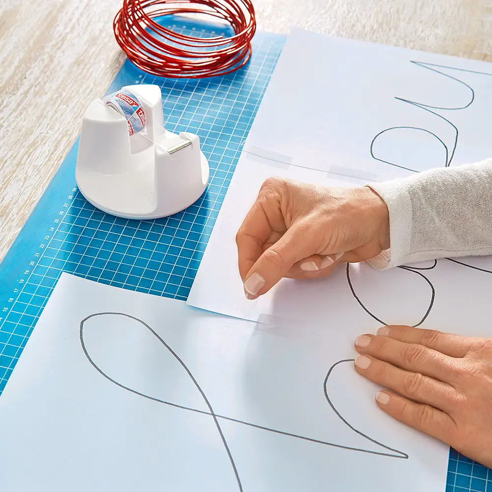 Using transparent tape to create your template for a wire writing sign