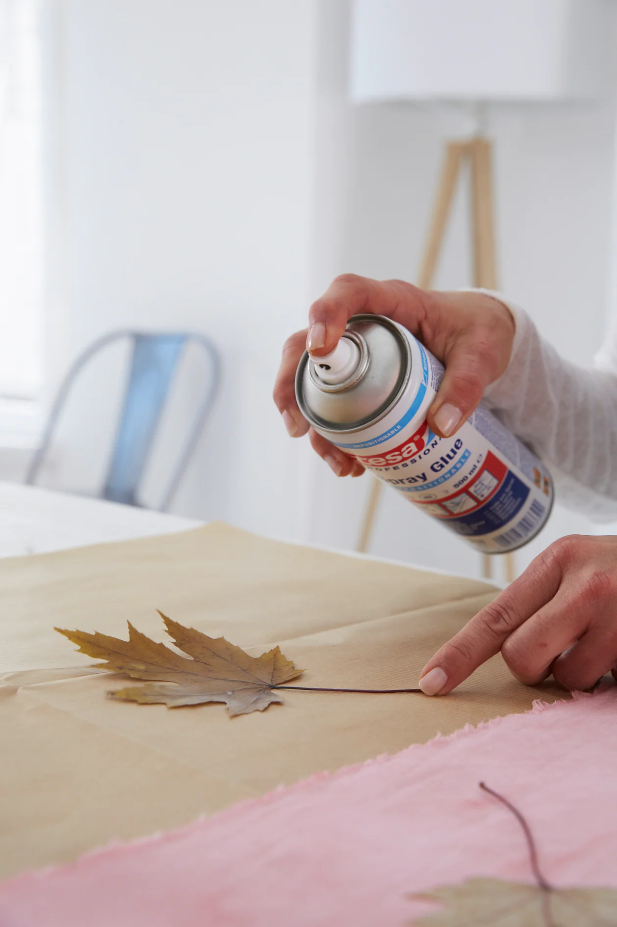 Spray one side of each leaf with spray glue.