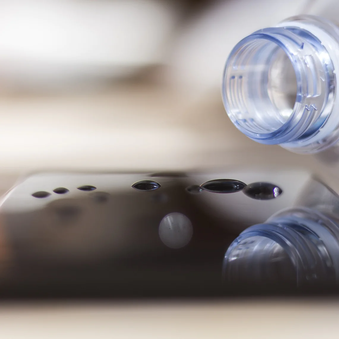 Water spilled from a bottle onto a smartphone