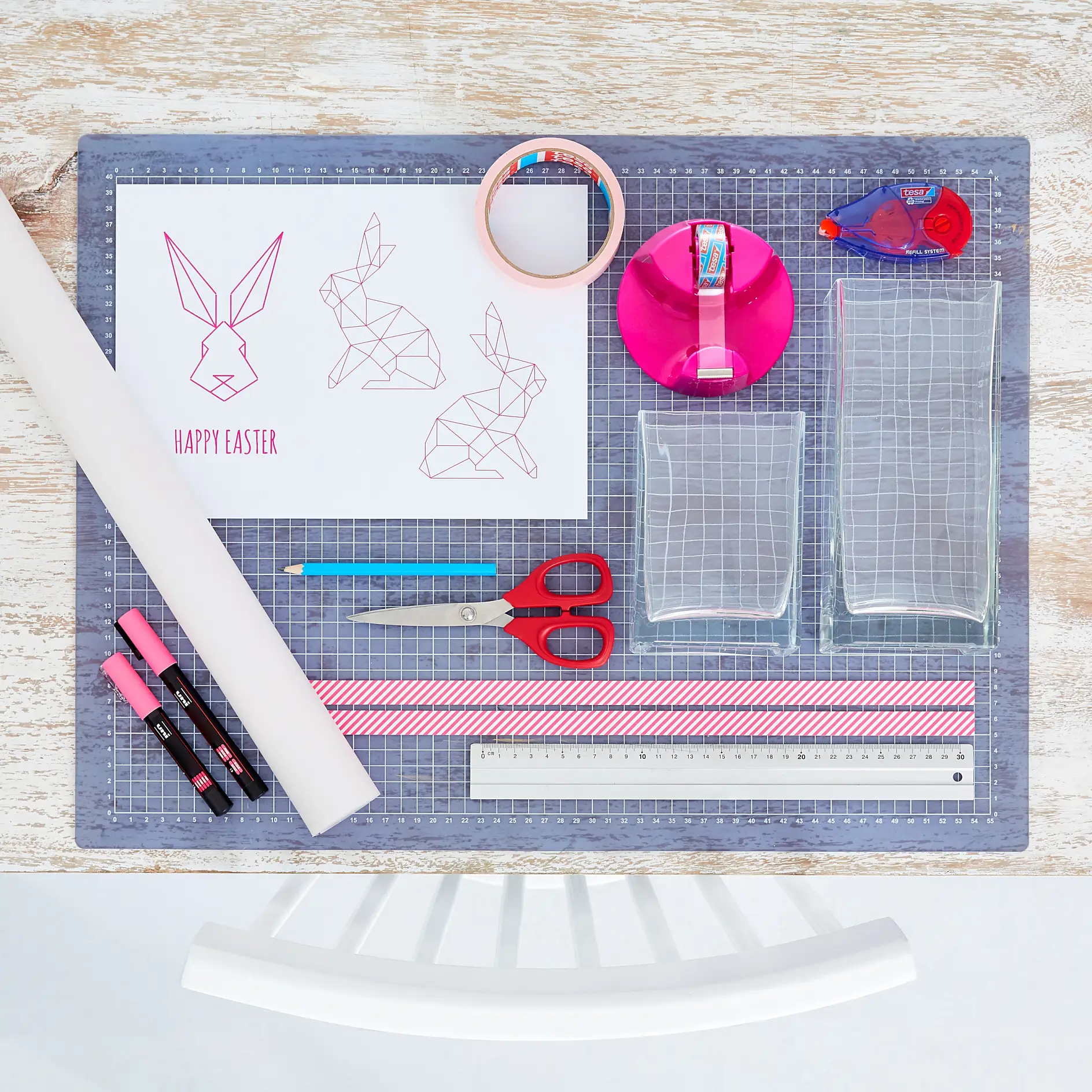 We need: 
Printed bunny template, sturdy tracing paper, neon pink chalk pen, scissors, pencil, ruler, paper strip with neon pattern (1.5 cm wide), square glass lanterns, tesa® Masking Tape for Wallpaper, tesa Glue Roller Permanent ecoLogo®, tesa Easy Cut® Compact Desk dispenser + tesafilm® crystal clear.
Time: approx. 15 minutes per Easter Light