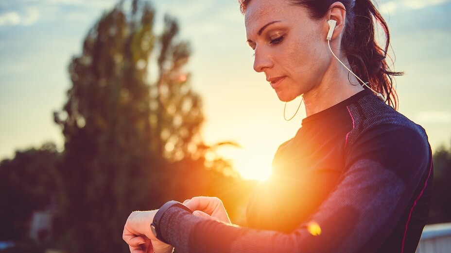 Women checking fitness tracker Woman monitoring her progress on smart watch