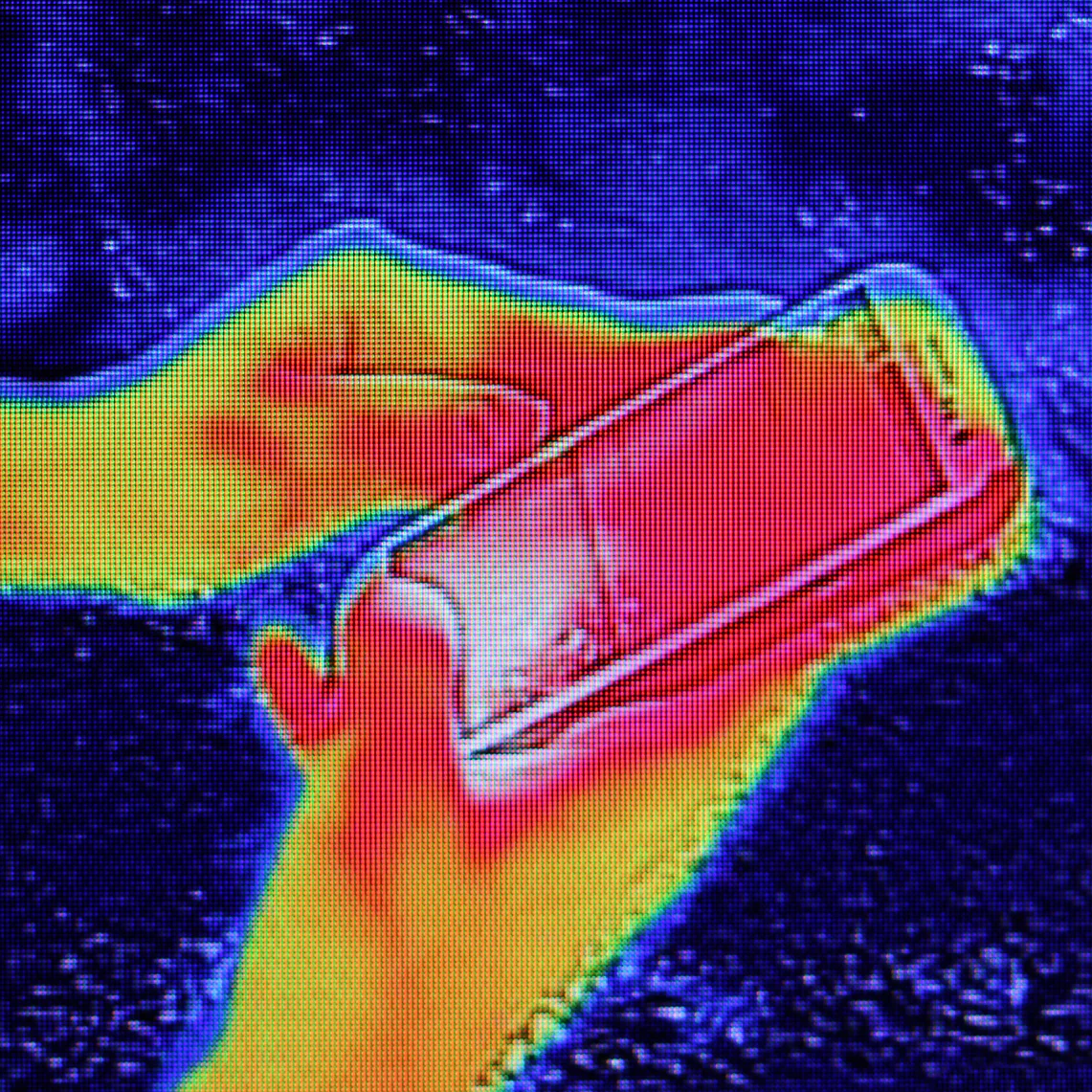 Infrared thermography image showing the heat emission when Young girl used smartphone or cell phone