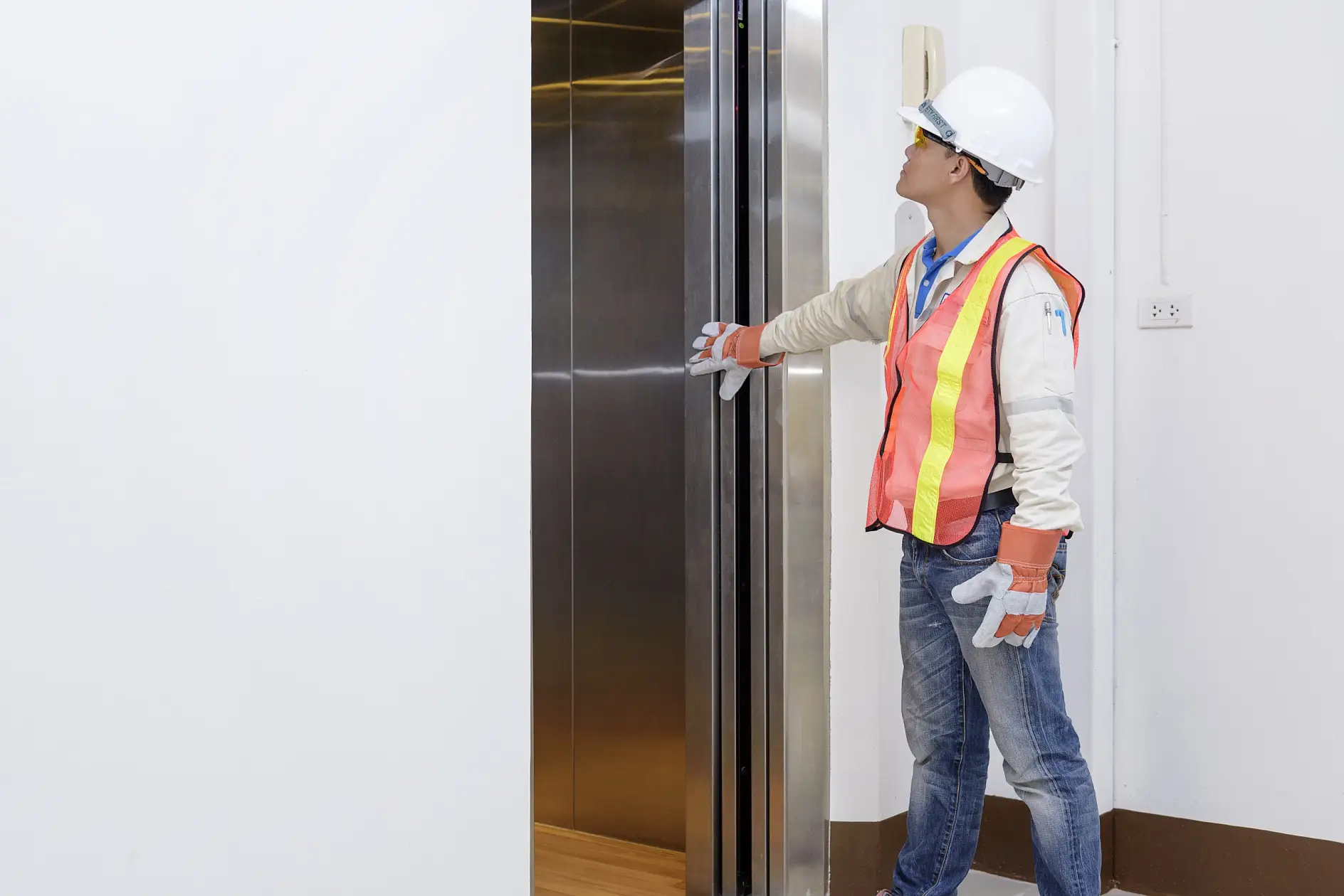Technician investigating elevator doors