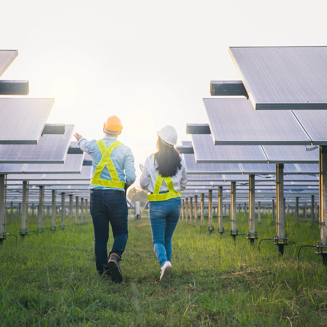 Male and female employee maintenance panels collect solar energy. Engineer working on checking and maintenance equipment at industry solar power.
