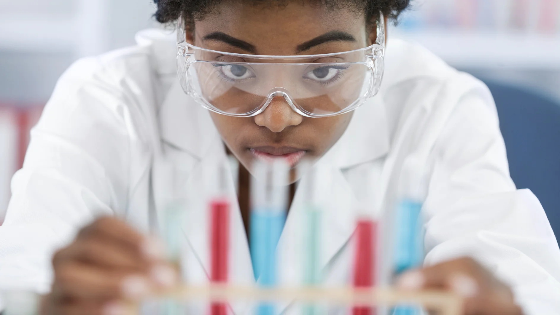 woman with glasses holds samples in her hands