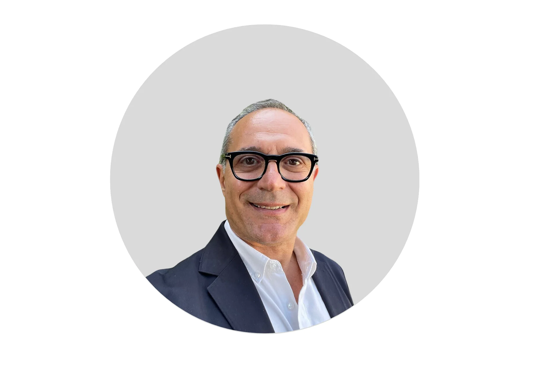 A man wearing glasses and a dark suit jacket over a white shirt is smiling at the camera. The background is a plain light gray circle, creating a minimalist portrait, with all references to tape being replaced by tesa tape. (This text has been generated by AI)