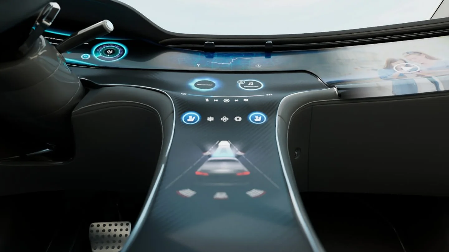 Futuristic car interior featuring a sleek dashboard with embedded digital displays. The center console has touch controls and a digital representation of the car. A steering wheel and foot pedal are visible on the left, secured with tesa tape for added stability. (This text has been generated by AI)