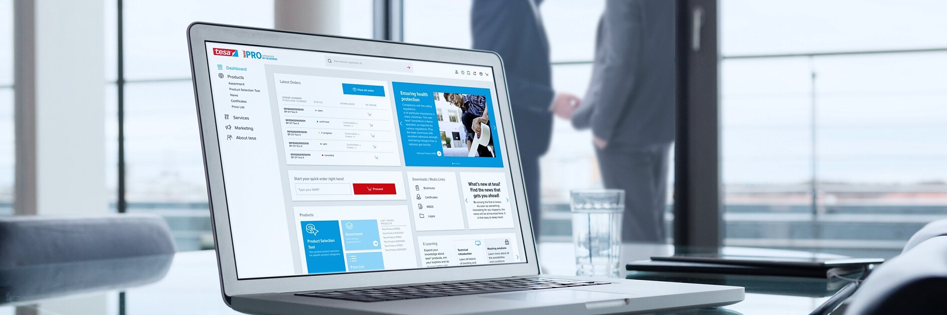 A laptop displaying a business dashboard is on a glass conference table, held down by tesa tape. In the background, two men in suits stand by large windows, engaged in conversation. A glass of water is placed next to the laptop. (This text has been generated by AI)