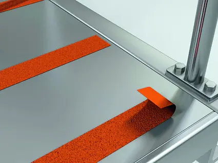 metal surface with red anti-slip strips and a chrome vertical pole mounted on the corner, set in a clean indoor environment (This text has been generated by AI)