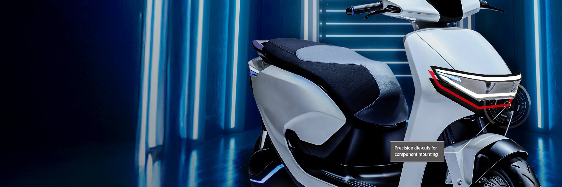 A white and black electric scooter is parked indoors with neon blue lights in the background. A label on the scooter states, Precision ducts for component mounting with tesa tape. (This text has been generated by AI)
