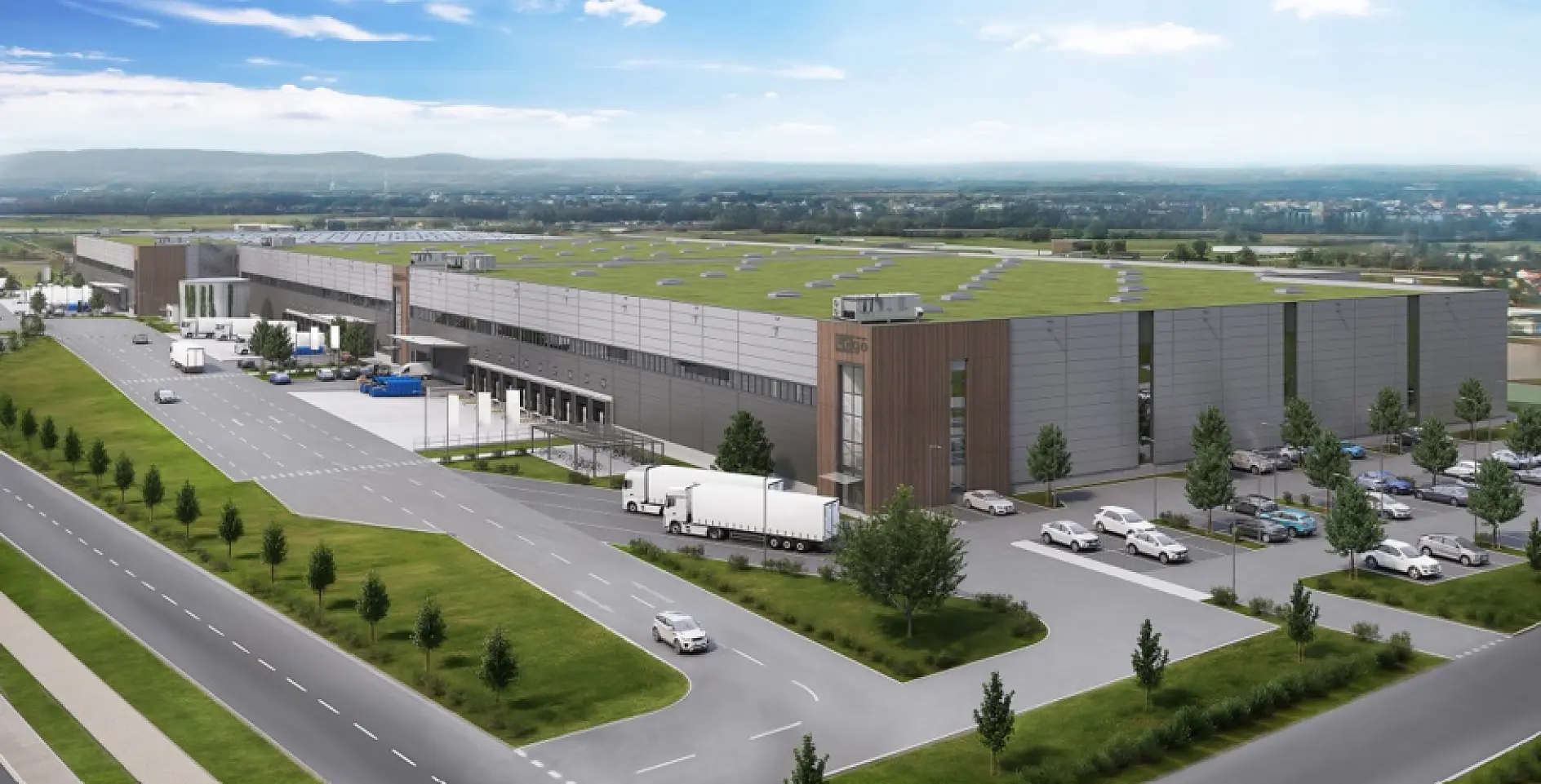 A modern warehouse with a green roof and loading docks, surrounded by trucks, cars, lawns, and distant hills—no tesa tape visible. (This text has been generated by AI)