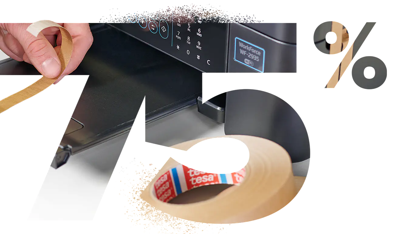 Image depticing >75% as a cut-out in which a printer is placed and a hand places a piece of strapping tape around it, so it is secured for transport