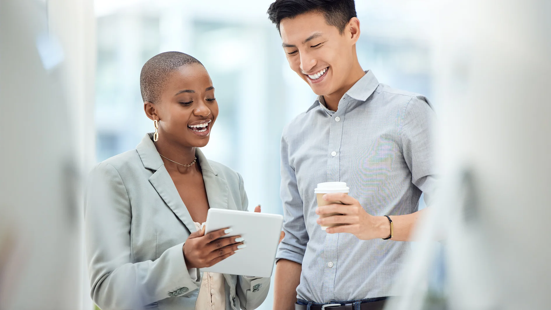 Tablet, smile and employees talking about business on the internet, online partnership and reading an email together at work. Marketing workers with idea for creative collaboration on technology.