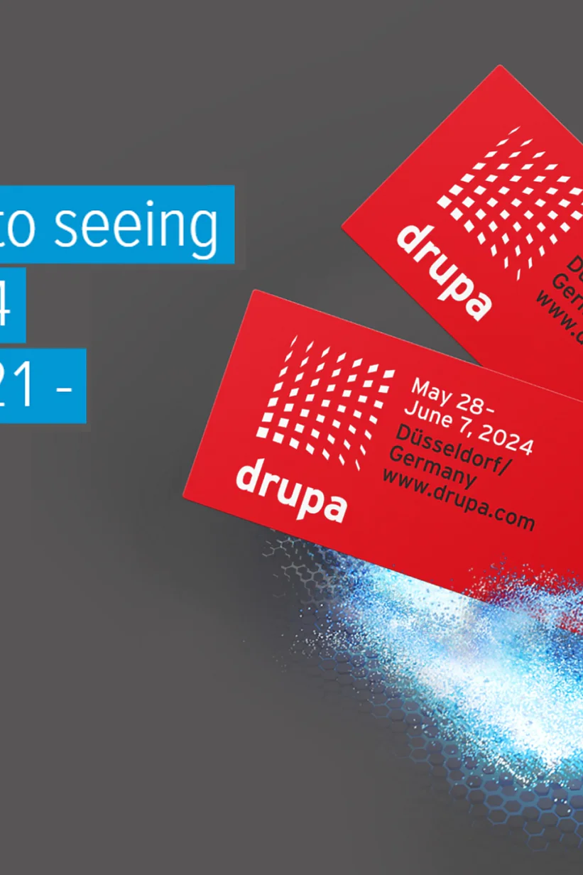 Two red tickets with white text for drupa 2024 are positioned to the right on a gray background, fastened securely with tesa tape. To the left, blue text reads, Looking forward to seeing you at drupa 2024 - hall 15, booth F21-. Blue light effects surround the tickets. (This text has been generated by AI)