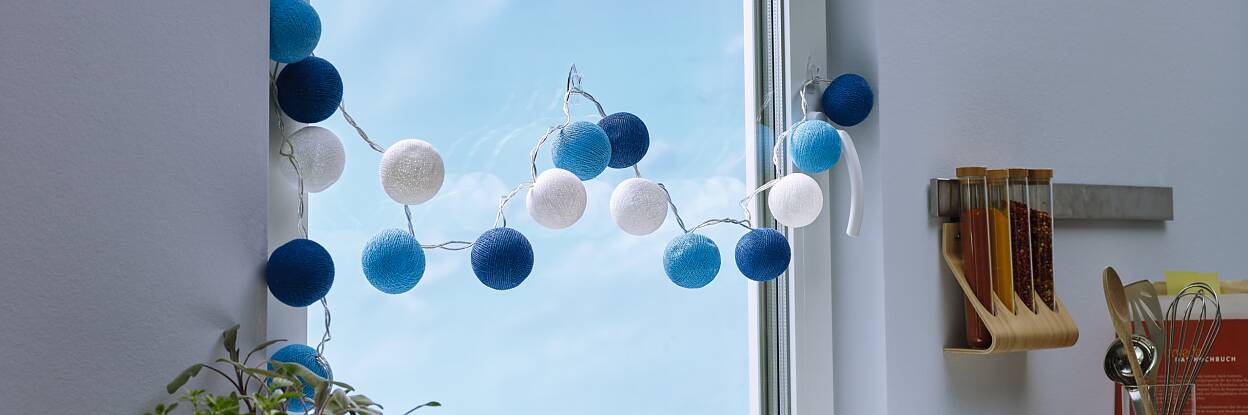 Transparent and nearly invisible adhesive hooks for mounting decorative objects on windows or mirrors.