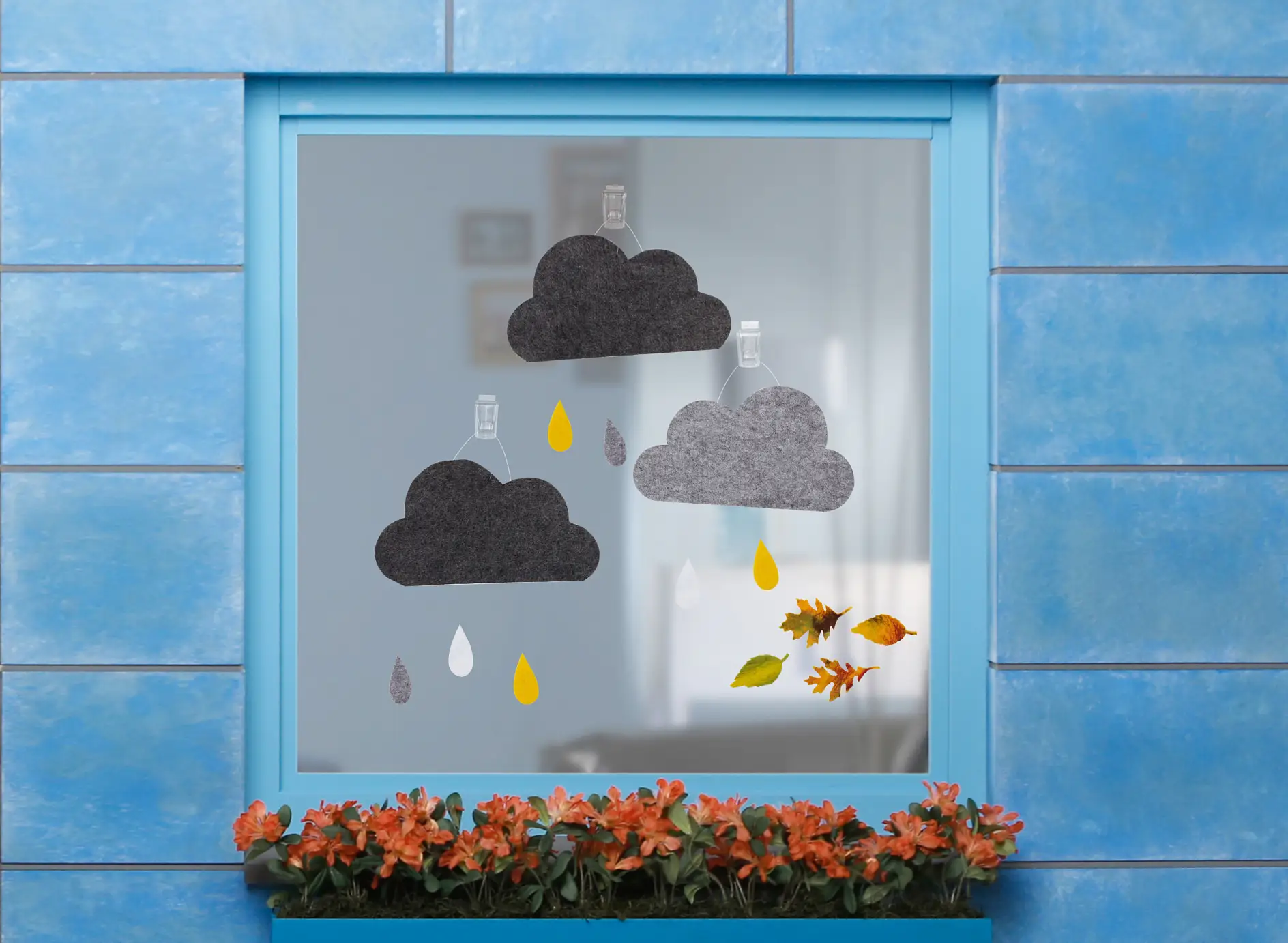 tesa Powerstrips® Transparent DECO Hooks LARGE with felt clouds and felt leaves on a windowpane
