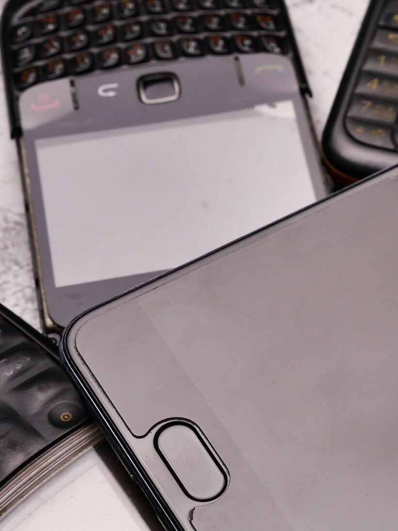 A smartphone on pile of obsoleted cellphones.