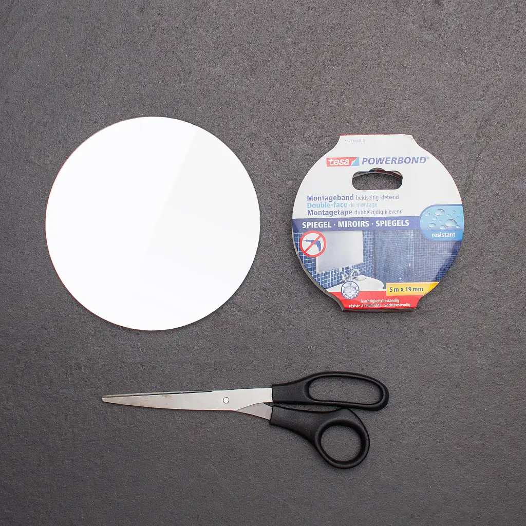 Scissors, small make-up mirror and tesa Powerbond® MIRROR adhesive tape.