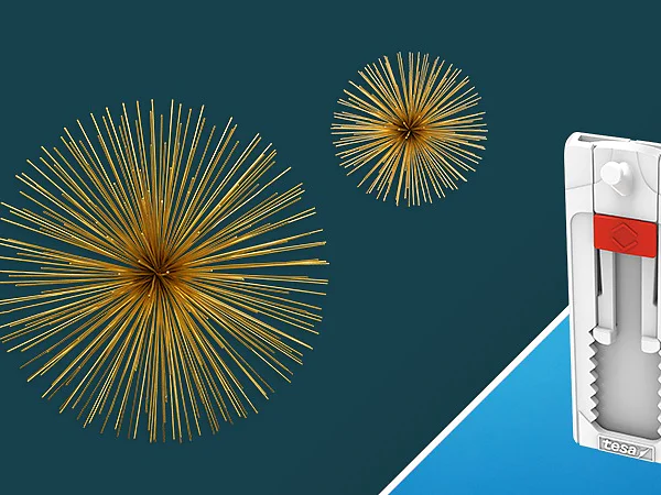 An image featuring two spherical, spiky golden structures against a dark teal background on the left, and a white, vertical plastic device with a red slider secured by tesa tape on a light blue background on the right. (This text has been generated by AI)