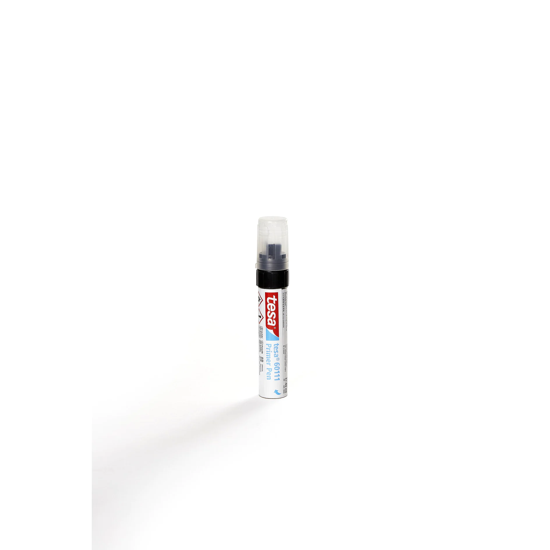 tesa brand adhesive glue pen standing upright on a white background with a shadow cast to the left (This text has been generated by AI)