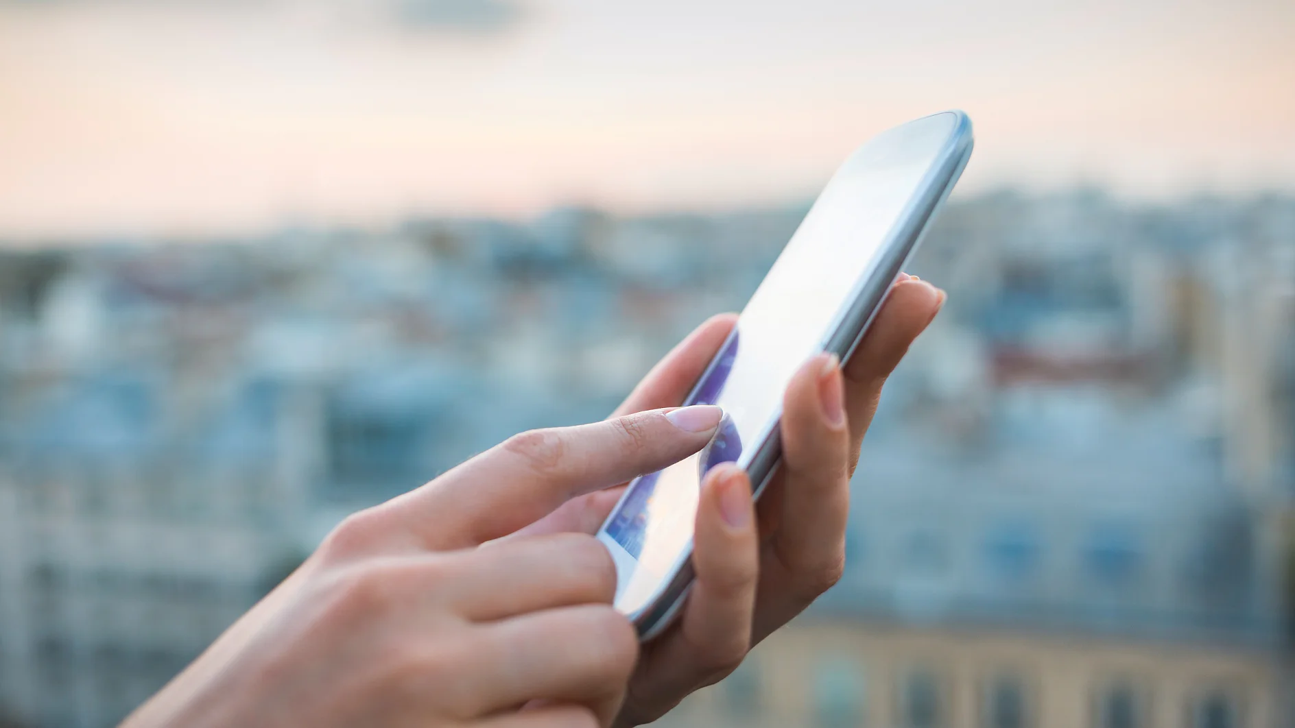 tesa woman using smartphone with city background