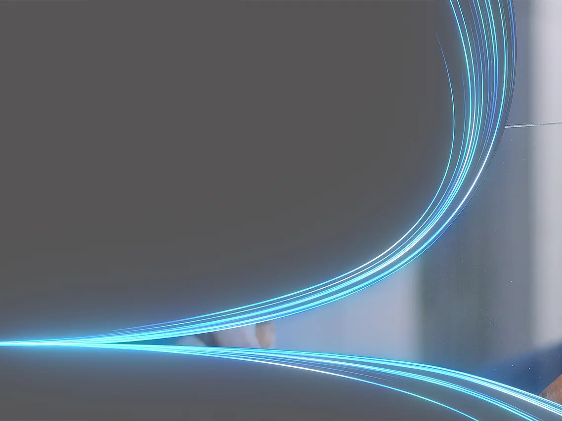 A man in a suit interacts with a transparent digital screen featuring glowing blue lines. The background is a gradient gray. (This text has been generated by AI)