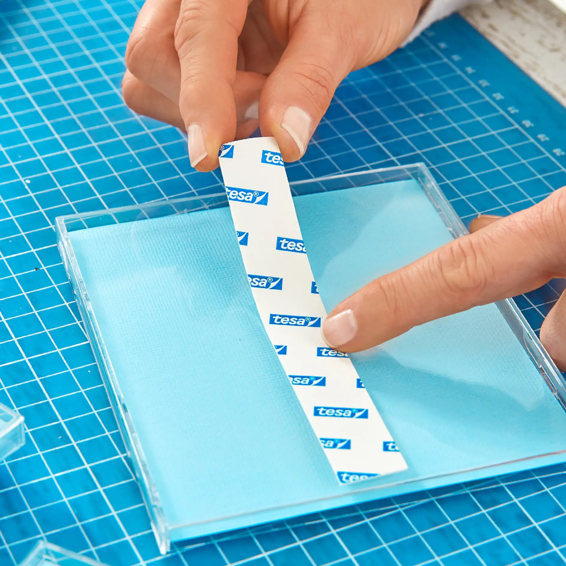 Making a DIY calendar – using tesa® Mounting Tape for Tiles & Metal to mount CD cases