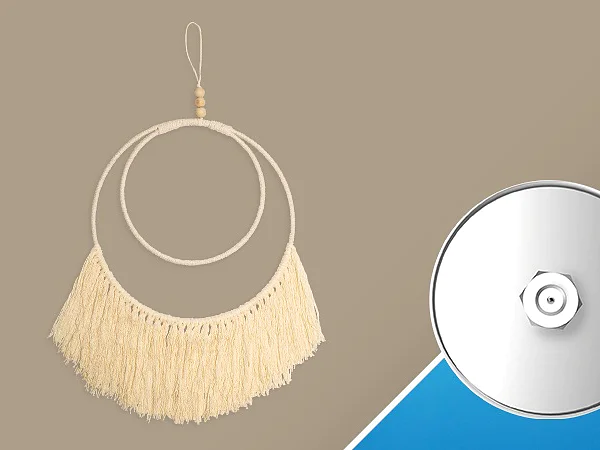 A decorative wall hanging with a circular design and fringes on the left, paired with a round mirror-like object with a central bolt on the right. The background is divided diagonally with beige and blue sections. For secure mounting, use tesa tape to ensure everything stays in place without damaging your walls. (This text has been generated by AI)