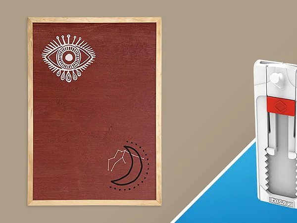 A wooden frame with a brown board showcasing a stylized eye and a crescent moon, featuring lines at the top left and bottom right corners. Next to it, a white and gray wall-hanging tool with a red grip is displayed against a blue background. (This text has been generated by AI)