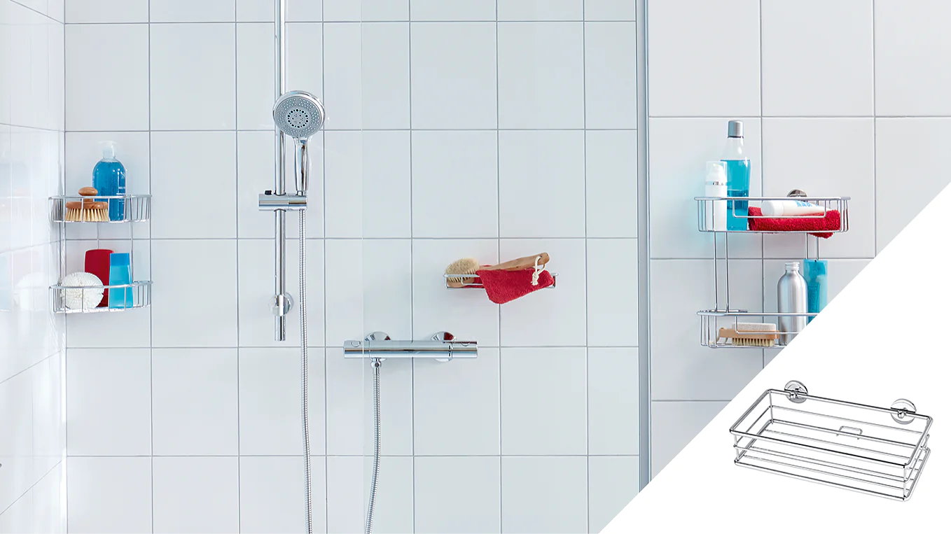 A white tiled shower with a chrome showerhead and controller. Three corner shelves hold toiletries including bottles and brushes. A red towel is draped over one shelf. An inset shows a wire rack attached with tesa tape suction cups. (This text has been generated by AI)