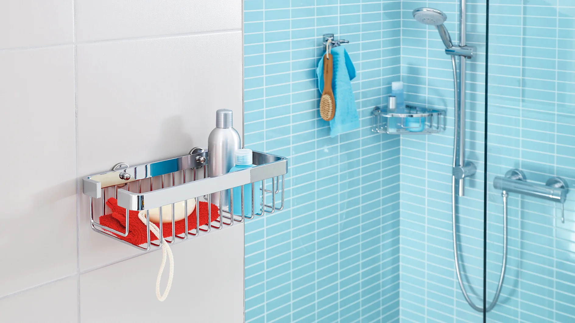 A modern bathroom with light blue tiles features a wall-mounted metal shower caddy holding a red cloth, a soap bar, and a bottle. A showerhead with an adjustable arm is on the right, along with a hanging washcloth and broom nearby. The installation is secured using tesa tape for added stability. (This text has been generated by AI)