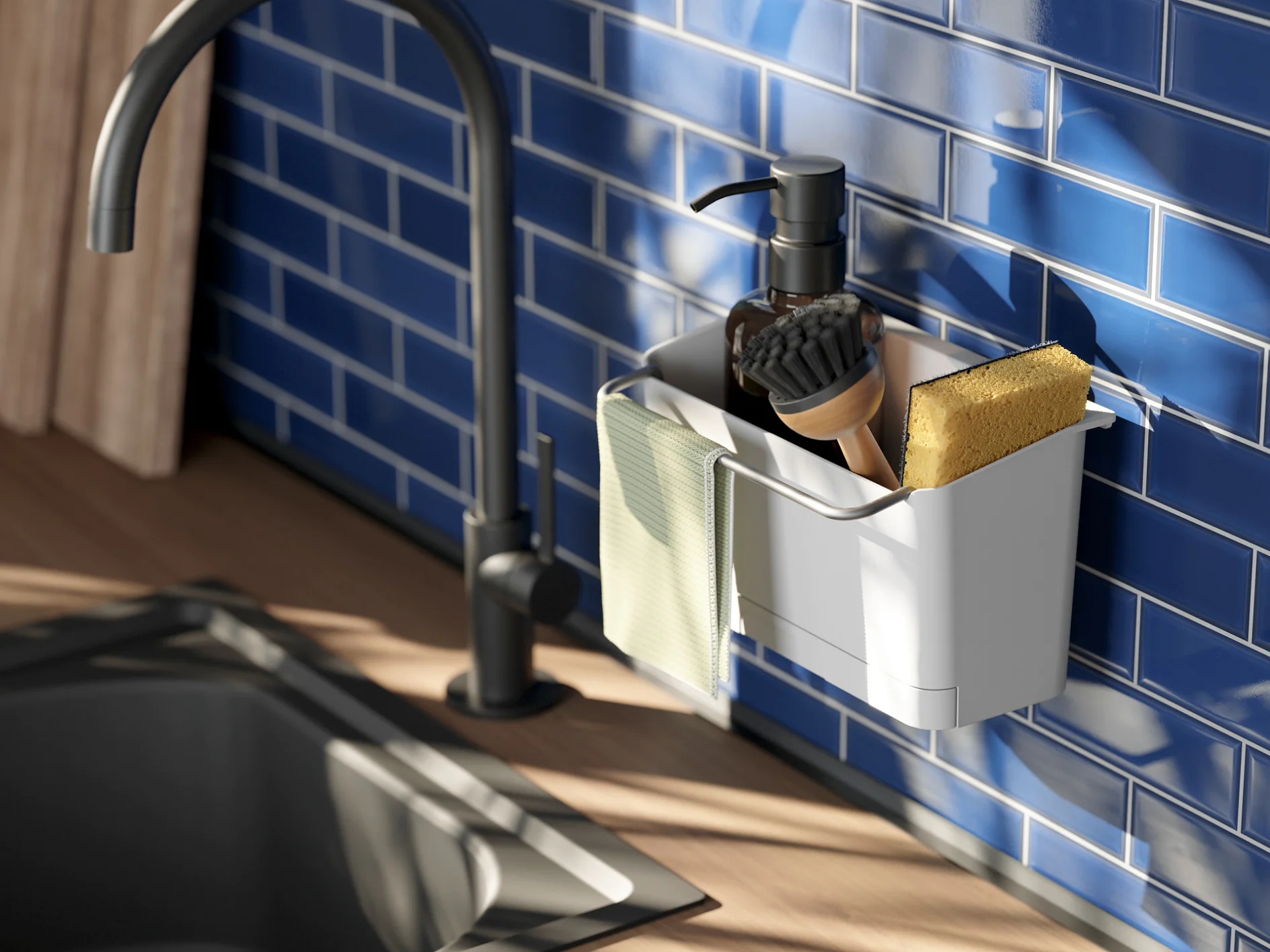 A kitchen sink area is shown with a black faucet, blue subway tile backsplash, and countertop. A container attached to the wall holds a soap dispenser, a scrubbing brush, a yellow sponge, and a green cloth. Shadows are visible on the tiles. (This text has been generated by AI)