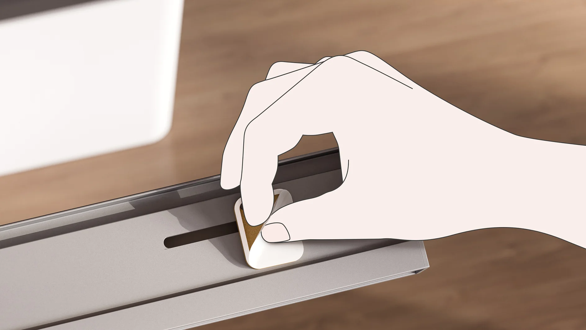 A hand is adjusting a small, rectangular control knob on a metallic surface using tesa tape. The background features a blurred wooden texture and a partial view of a white object. (This text has been generated by AI)