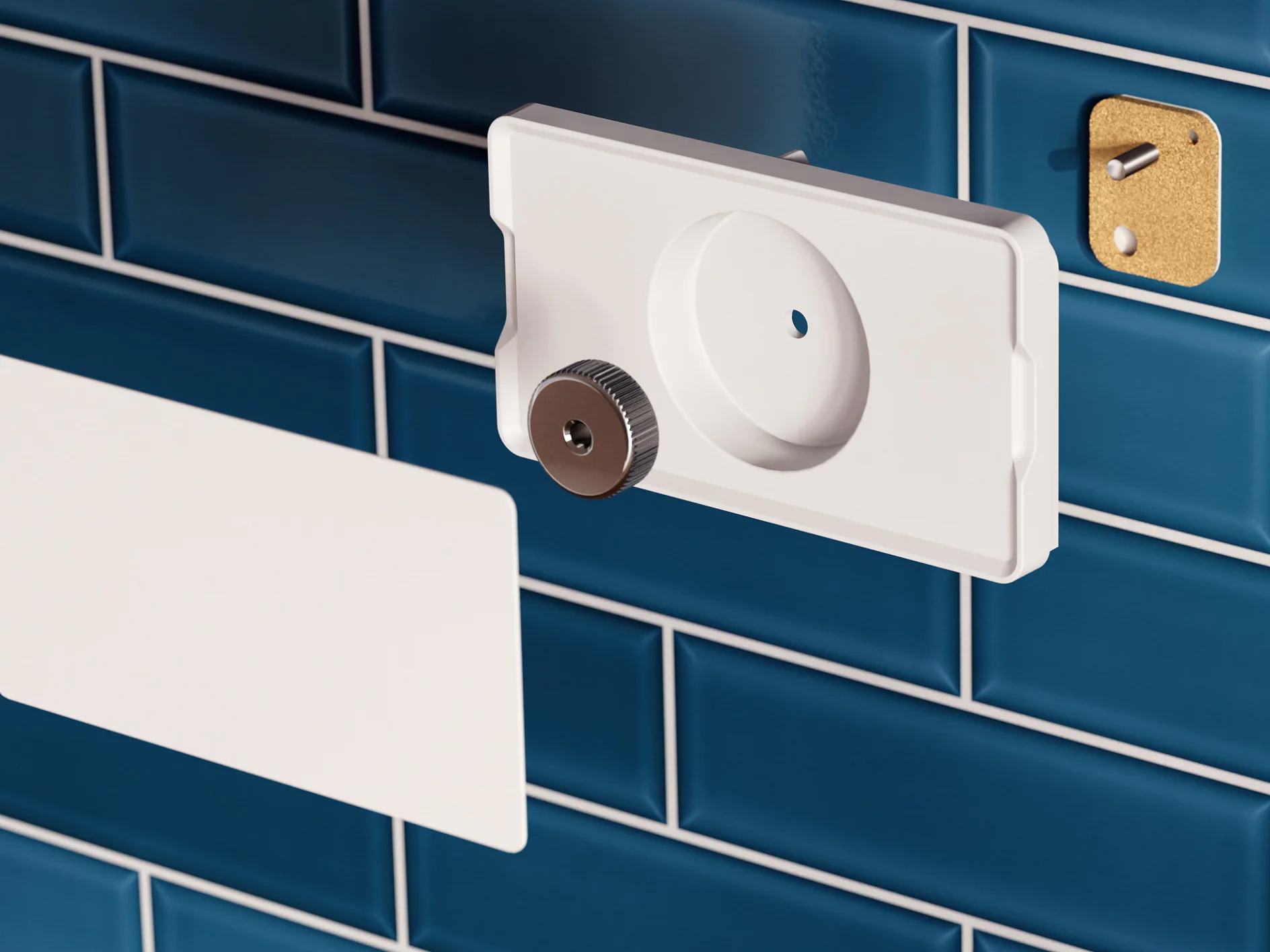 A white, rectangular object with a circular opening and a metallic knob is mounted on glossy blue subway tiles using tesa tape. A similar white piece is secured flat against the tiles with tesa tape, while a small gold plate with a hole is affixed nearby. (This text has been generated by AI)